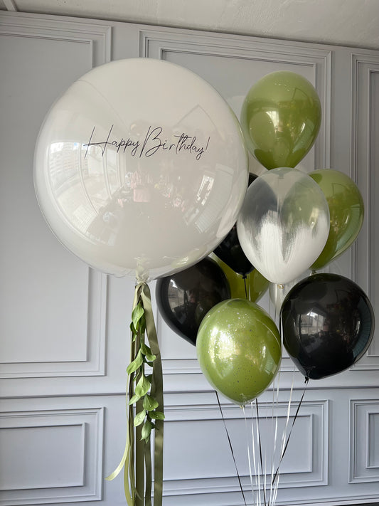 Jungle vibes balloon set with custom sign bubble balloon and green black balloons for celebration decor in New York