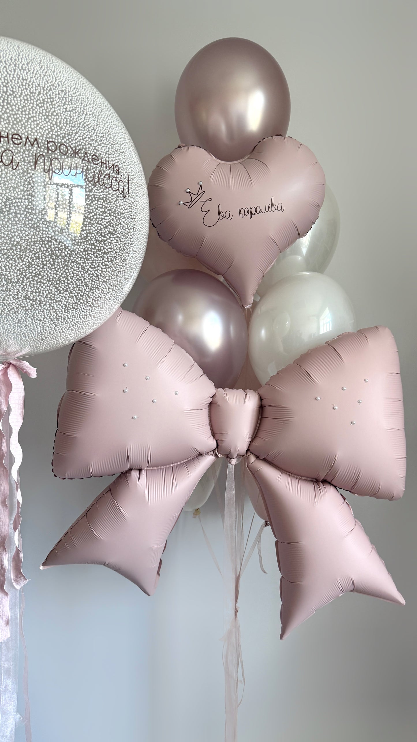 Close-up of pink bow balloon and custom bubble balloon for girls birthday decor in Brooklyn