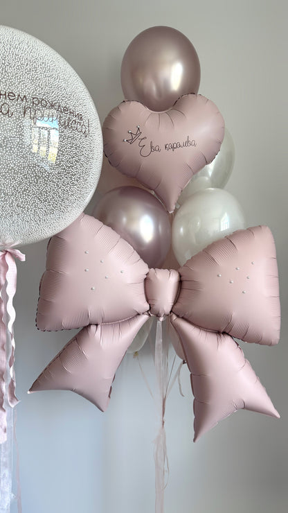 Close-up of pink bow balloon and custom bubble balloon for girls birthday decor in Brooklyn