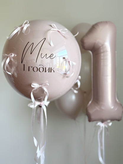 Close-up of blush birthday bubble balloon with number balloon for girls party decor in Brooklyn