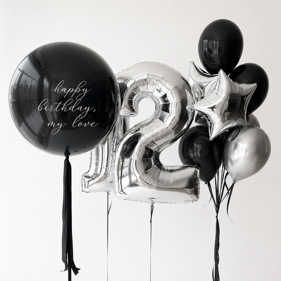 Midnight Luxe Number Balloon Set with a custom black bubble balloon, silver number balloons, and black and silver balloon bouquet in Manhattan