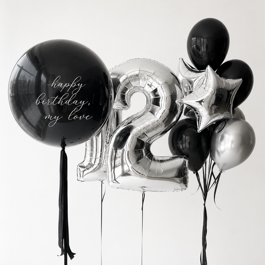 Midnight Luxe Number Balloon Set with a custom black bubble balloon, silver number balloons, and black and silver balloon bouquet in Manhattan