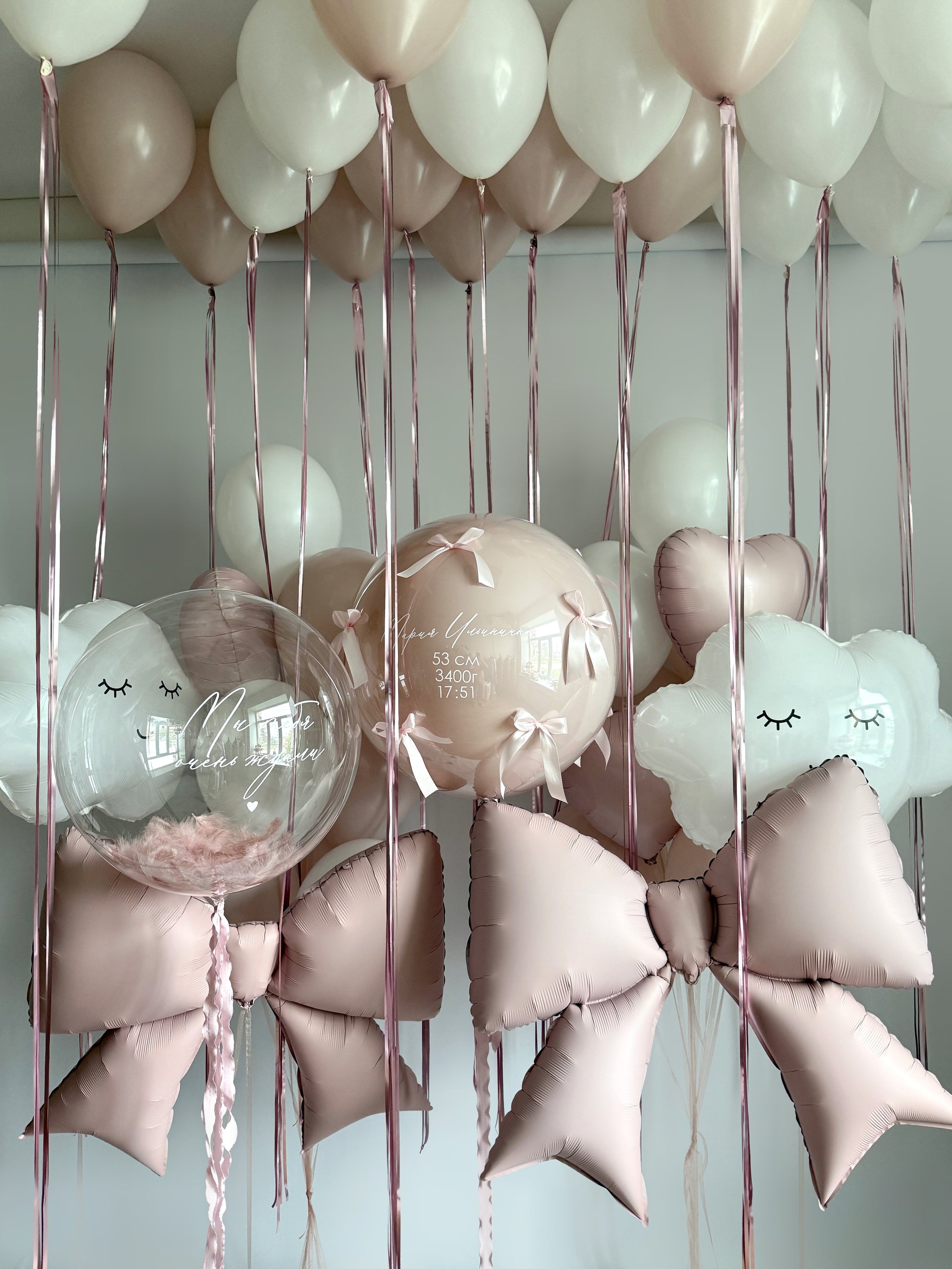 Luxury baby welcome balloon installation with bows, clouds, and ceiling balloons in Manhattan