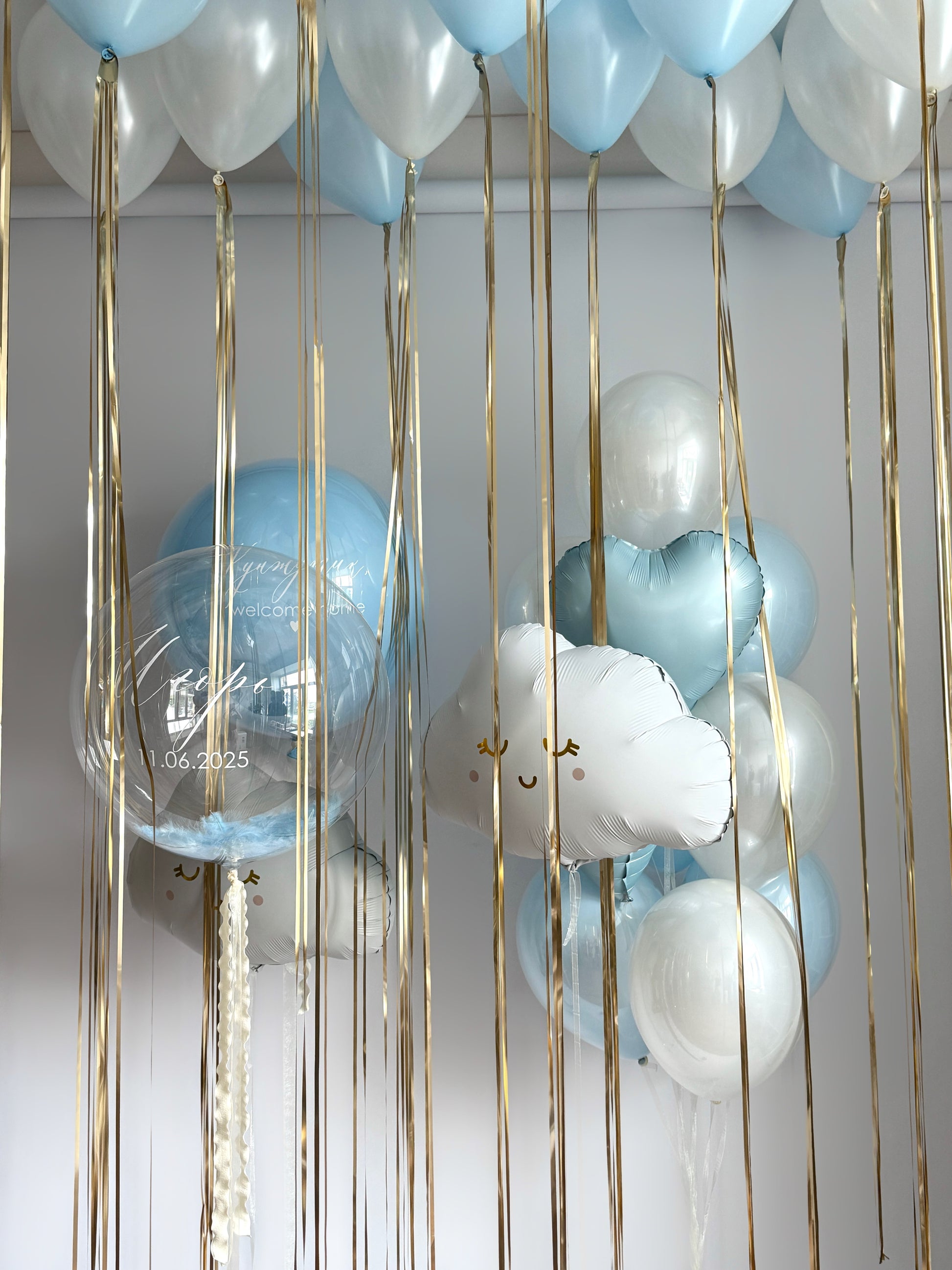 Luxury baby welcome balloon setup with blue bubble balloons, clouds, and ceiling decor in Brooklyn