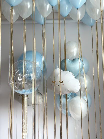 Luxury baby welcome balloon setup with blue bubble balloons, clouds, and ceiling decor in Brooklyn