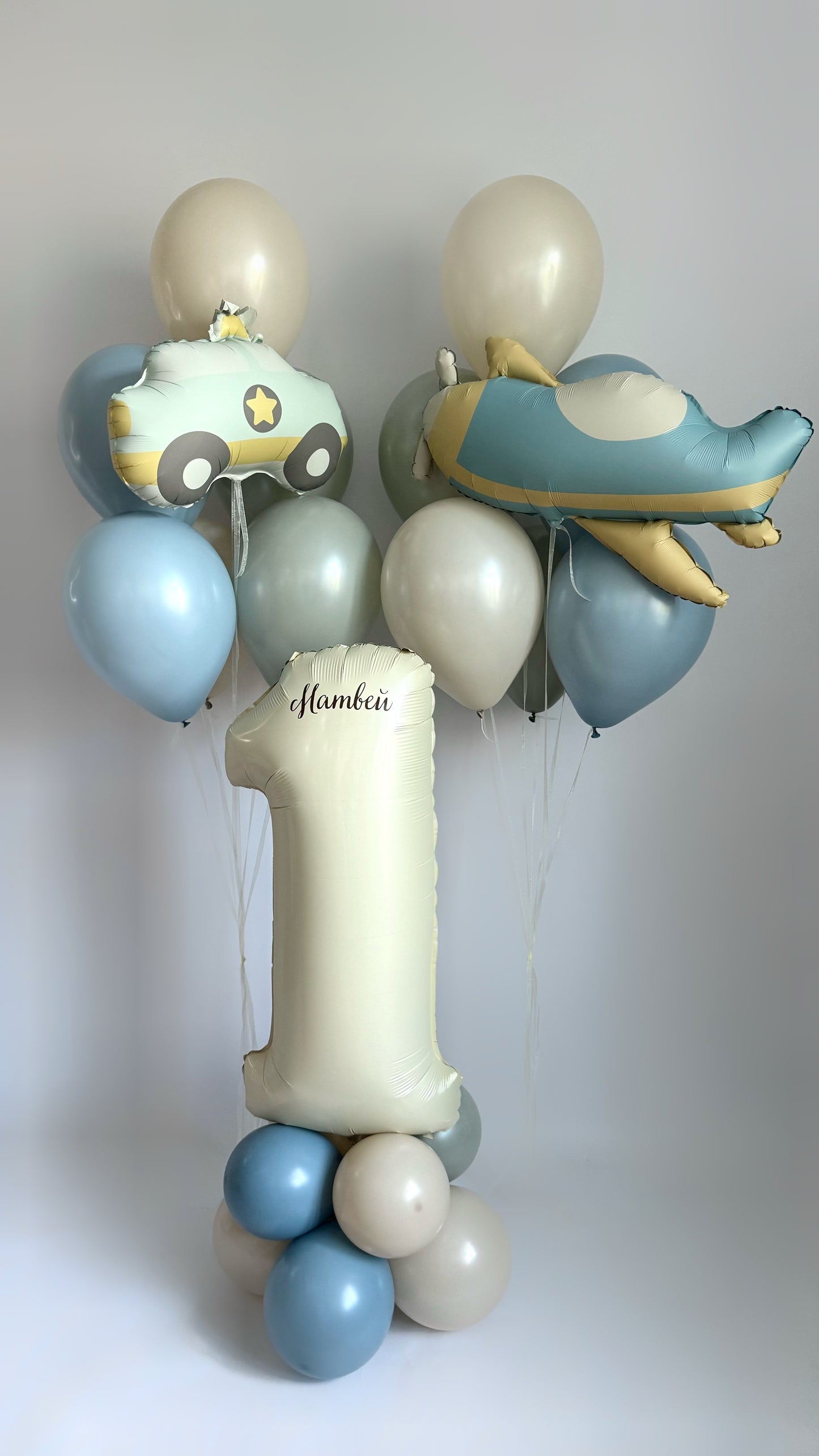 Personalized nude birthday number balloon stand with blue and gold balloons for kids party decor in New York