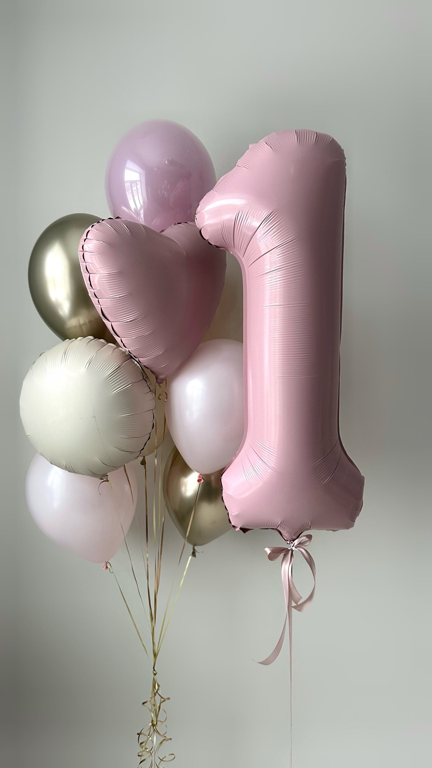 Number 1 balloon set with pink number one balloon, heart balloons, and confetti balloons for first birthday decor in New York