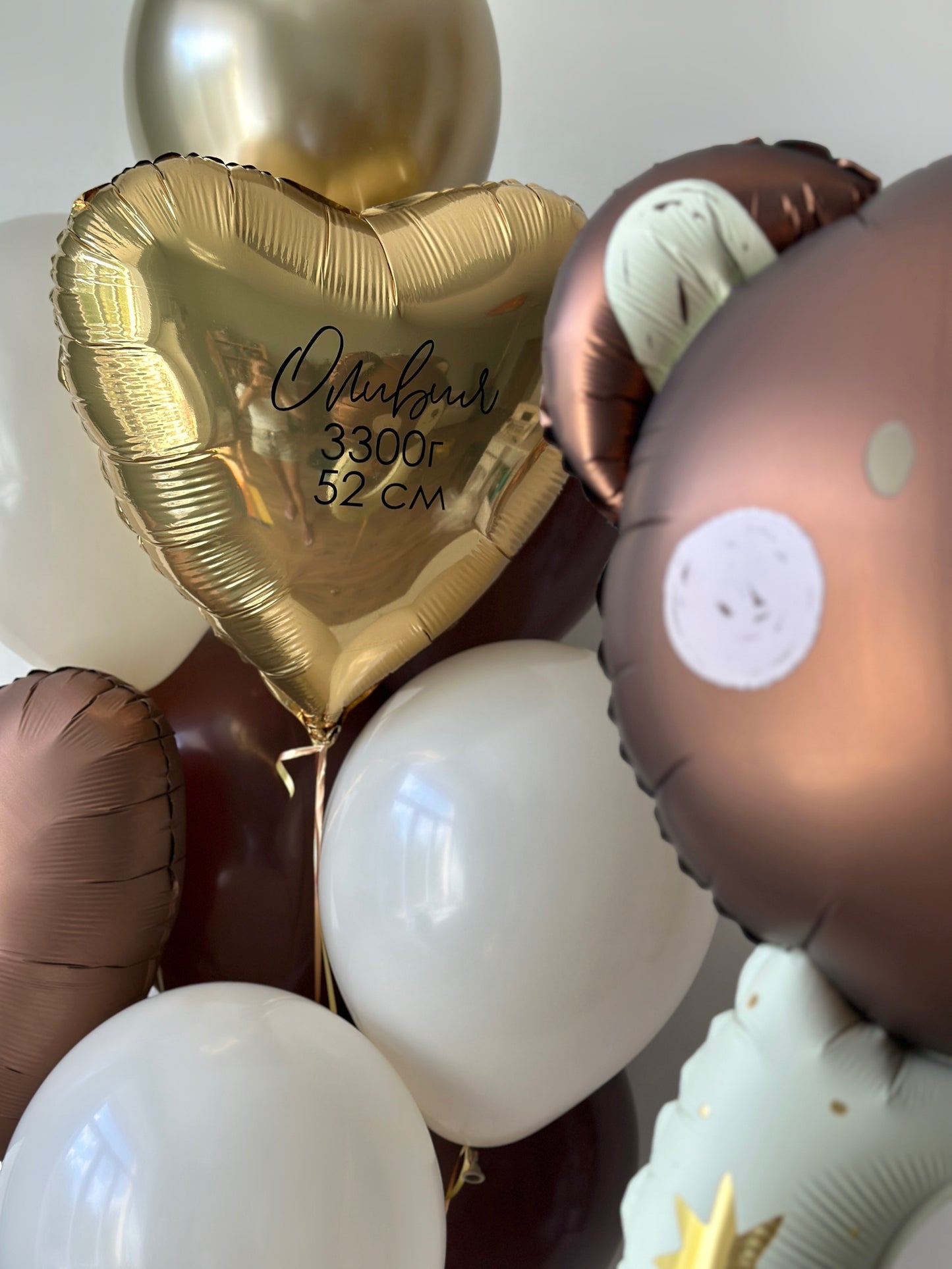 Close-up of baby balloon set with gold heart balloon and teddy bear foil balloon in Brooklyn