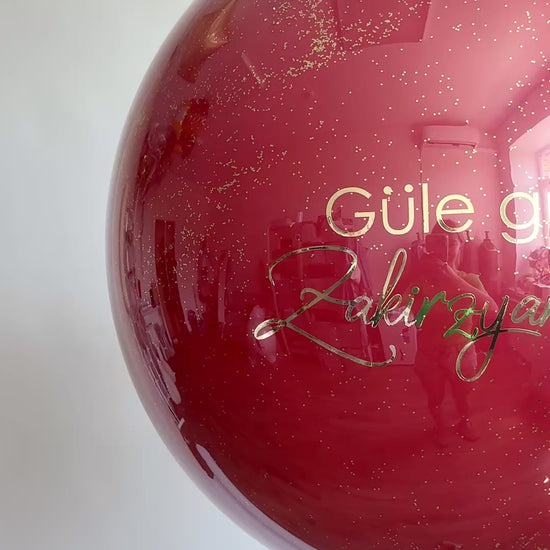 Video of burgundy bachelorette bubble balloon with custom sign for girls night decor in Brooklyn
