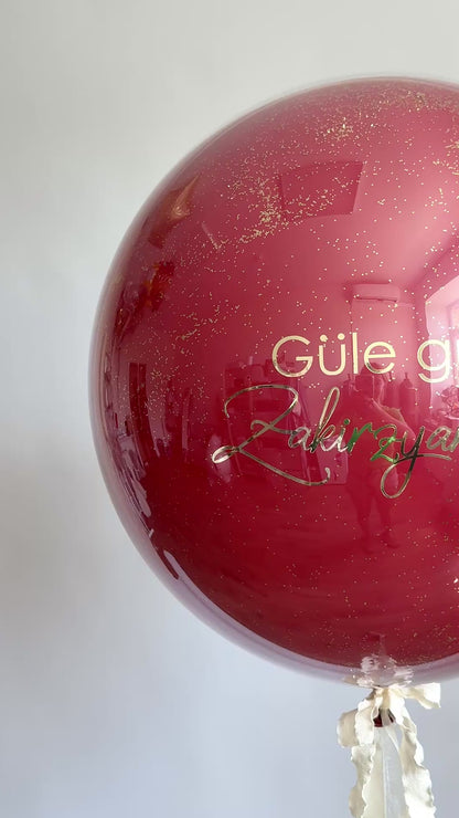 Video of burgundy bachelorette bubble balloon with custom sign for girls night decor in Brooklyn