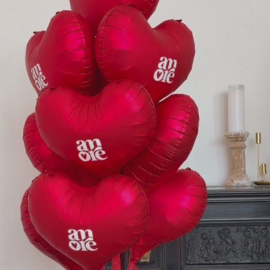 Close-up of red heart balloon bouquet for romantic celebration decor in New York