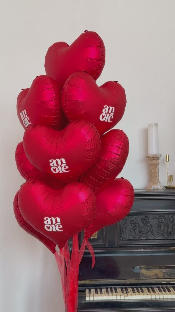 Close-up of red heart balloon bouquet for romantic celebration decor in New York