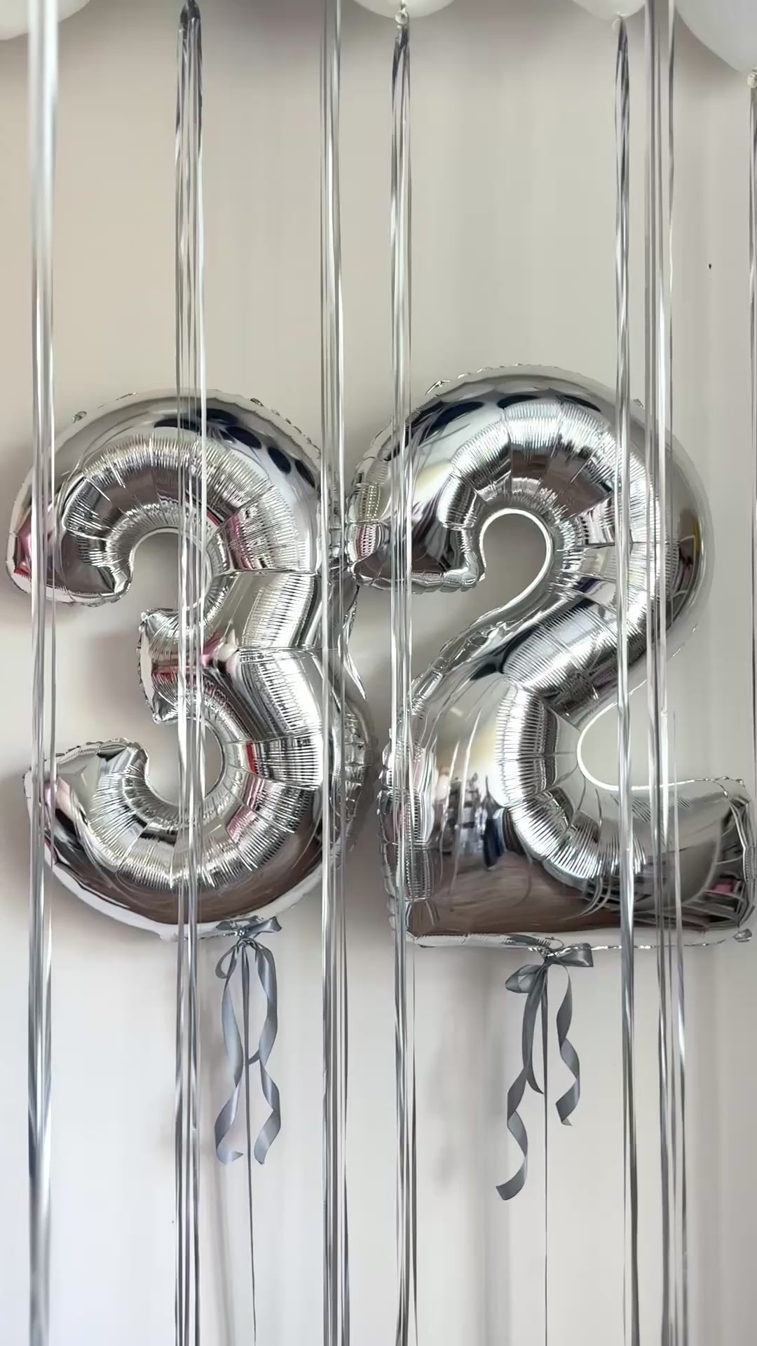 Video of silver number balloons with ceiling balloon setup for celebration decor in Brooklyn