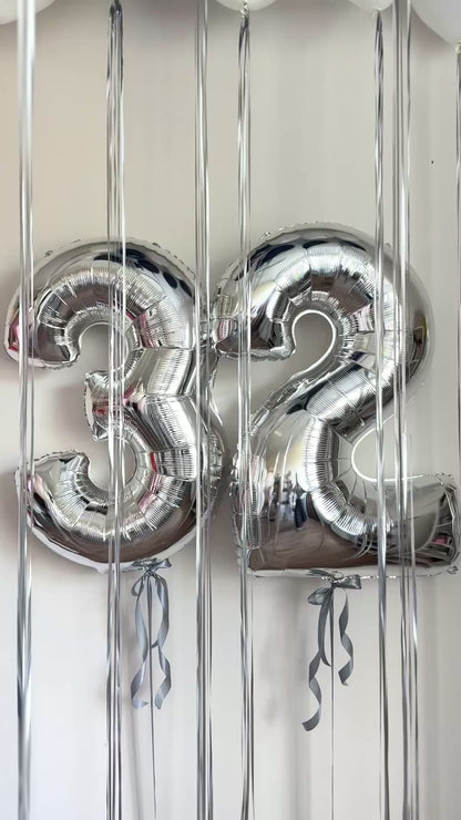 Video of silver number balloons with ceiling balloon setup for celebration decor in Brooklyn