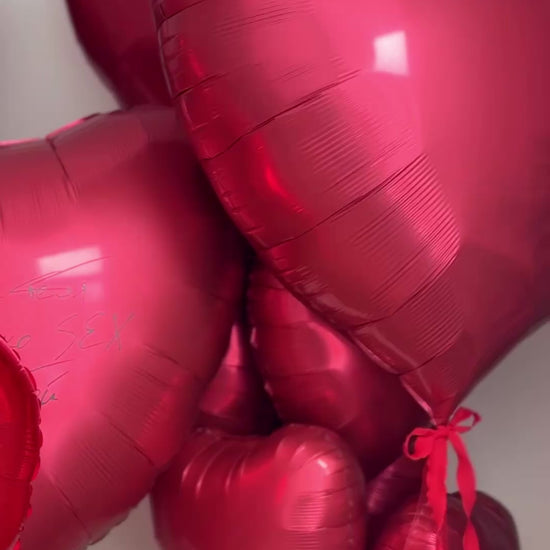 Close-up of personalized heart balloons with photo details for proposal decor in Brooklyn