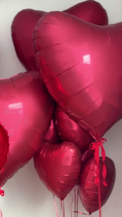 Close-up of personalized heart balloons with photo details for proposal decor in Brooklyn