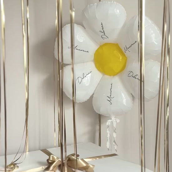 Video of custom gender reveal box with gold ribbons and daisy balloon detail in Manhattan