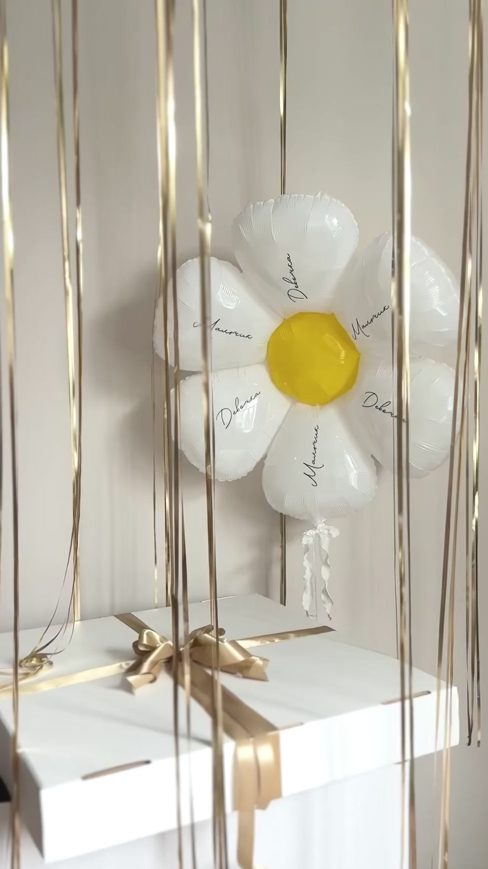 Video of custom gender reveal box with gold ribbons and daisy balloon detail in Manhattan