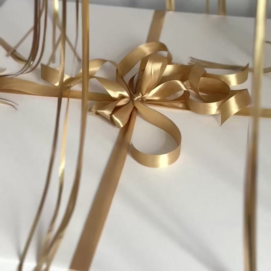 Video of custom gender reveal balloon box with floating balloons and ribbon detail in NYC
