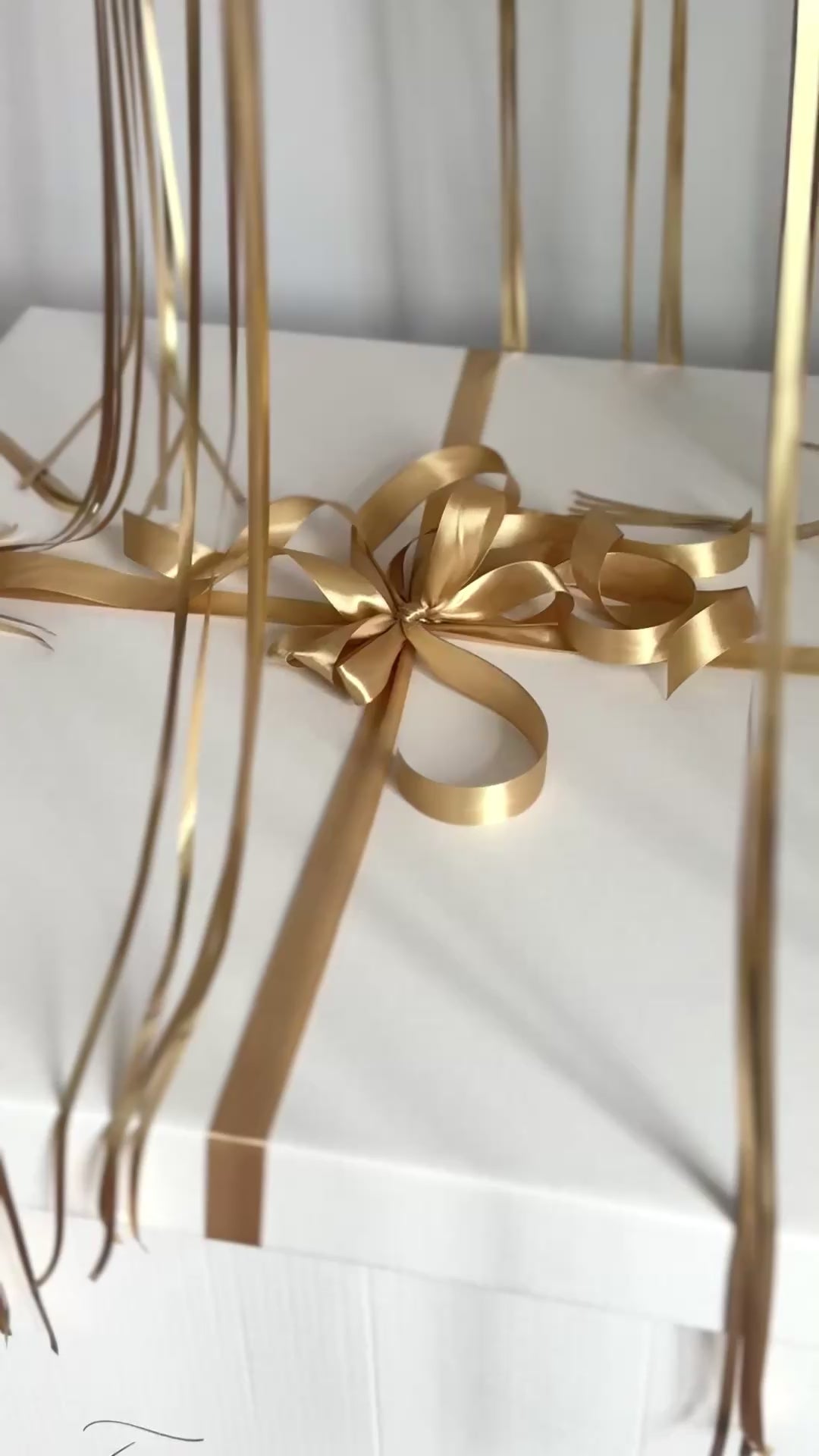 Video of custom gender reveal balloon box with floating balloons and ribbon detail in NYC

