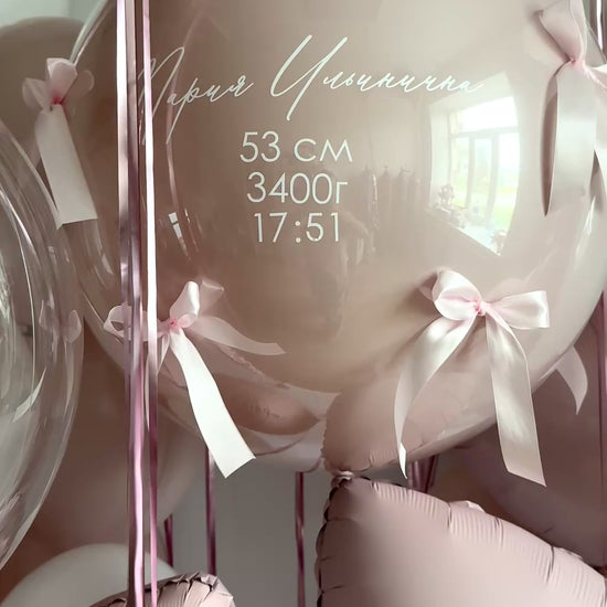 Video of personalized newborn welcome bubble balloon with bows and soft blush styling in Brooklyn