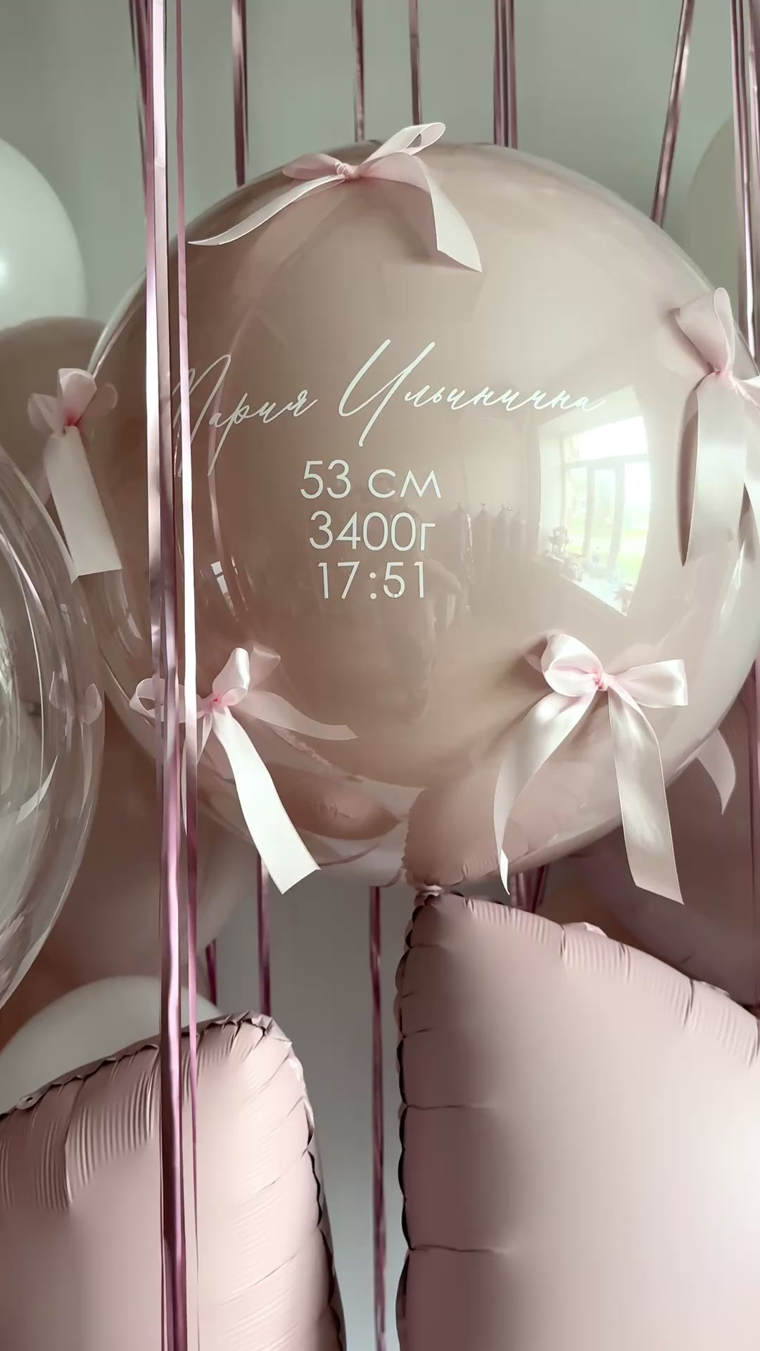Video of personalized newborn welcome bubble balloon with bows and soft blush styling in Brooklyn