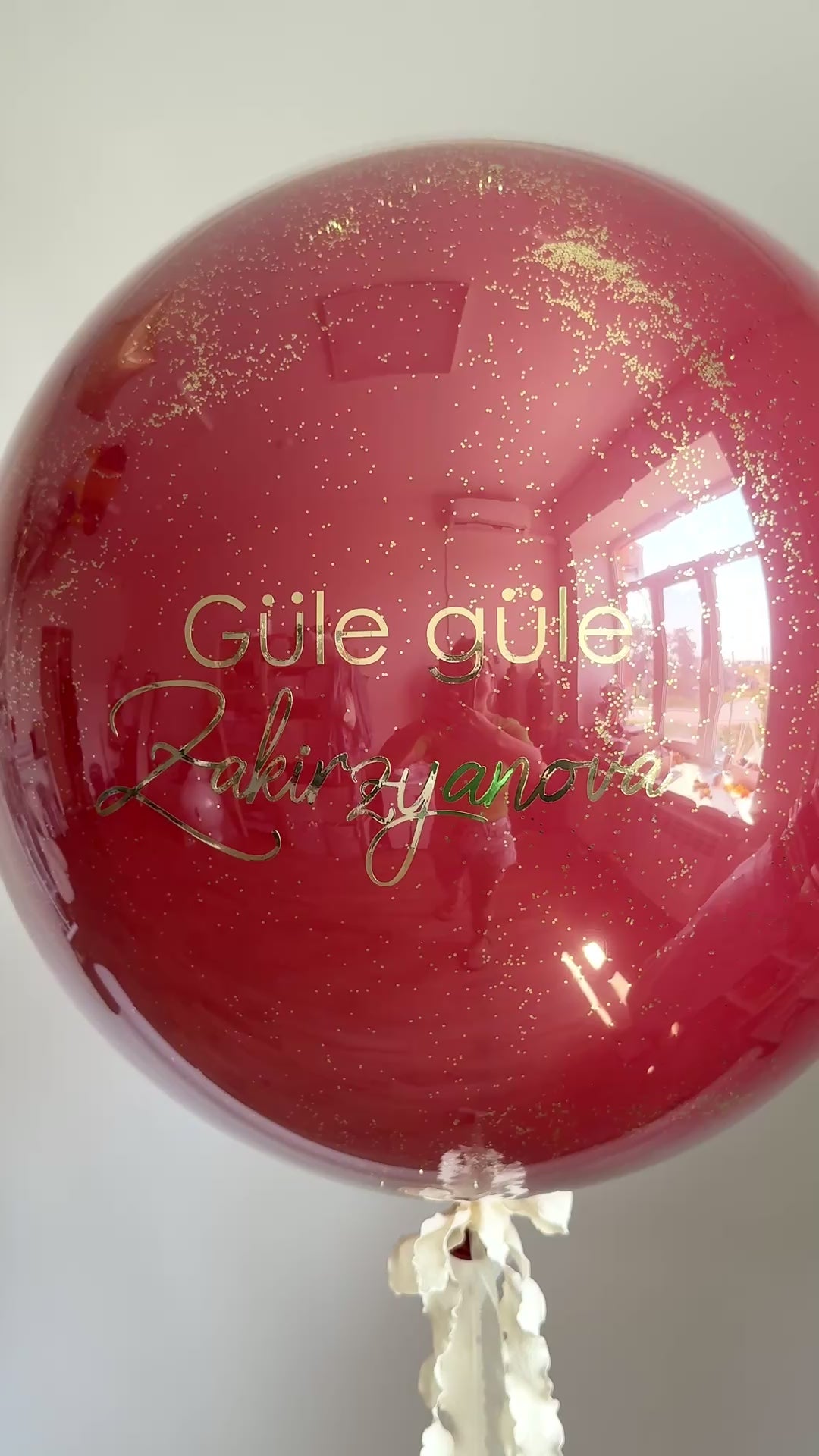 Video of personalized bachelorette bubble balloon with glossy burgundy finish in Manhattan