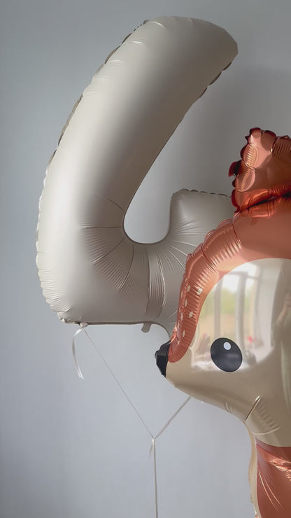 Close-up of woodland deer balloon with number balloon for first birthday party decor in Brooklyn