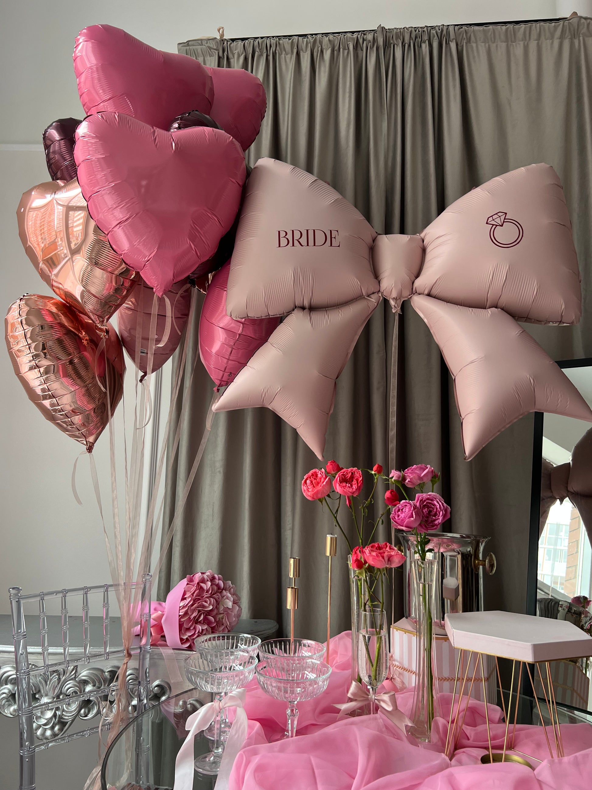 Raspberry balloon set with custom bow balloon and pink heart balloons for party decor in New York
