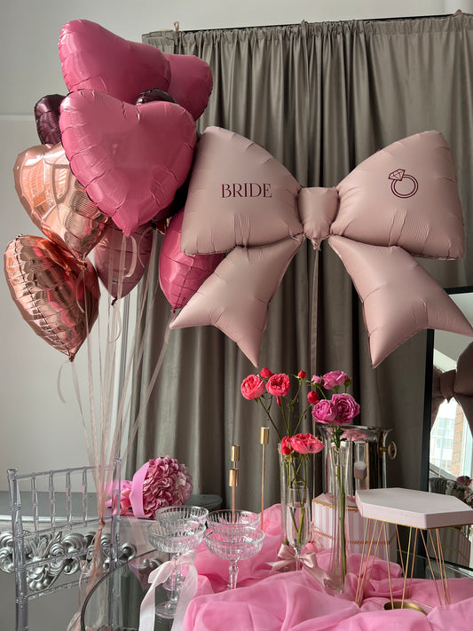 Raspberry balloon set with custom bow balloon and pink heart balloons for party decor in New York