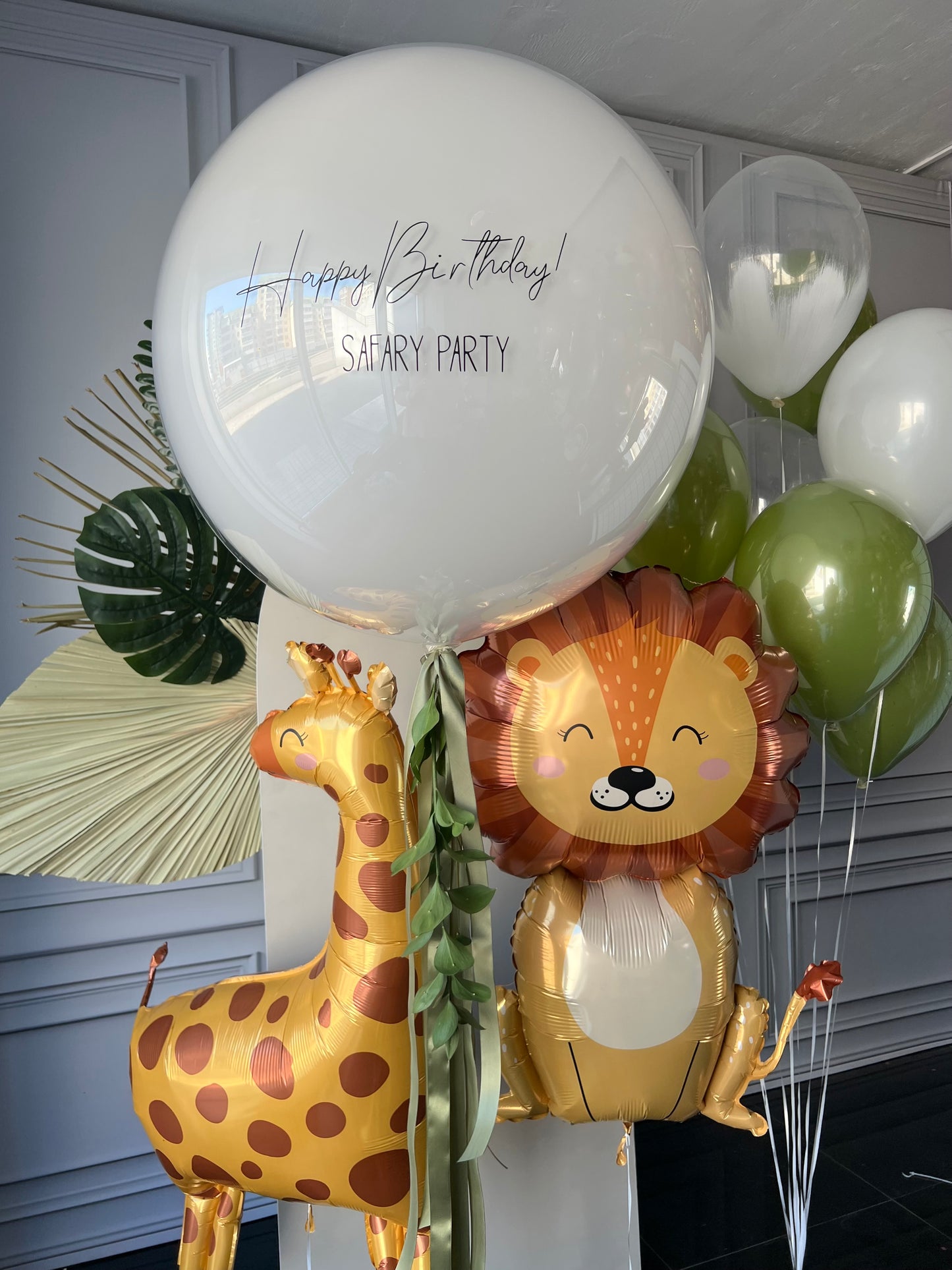 Safari party balloon set with custom sign bubble balloon, animal foil balloons, and green birthday decor in New York