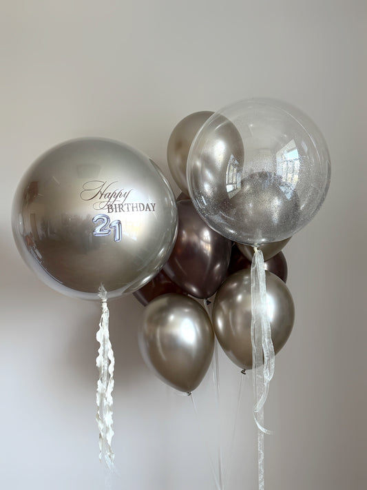 Silk gold balloon set with large bubble balloon, clear shine balloon, and elegant neutral decor in New York