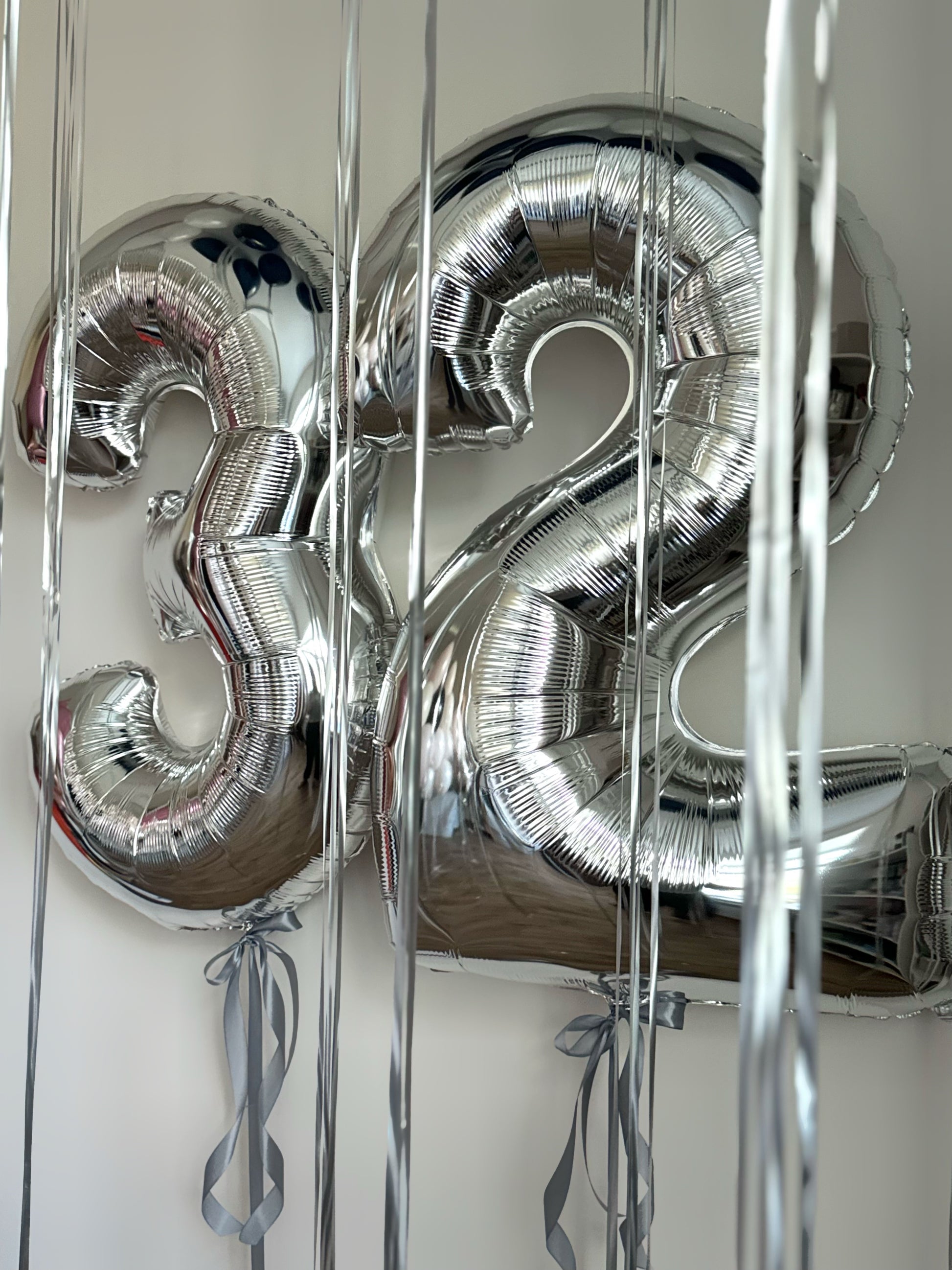 Silver number balloon ceiling set with helium balloons for birthday decor in New York
