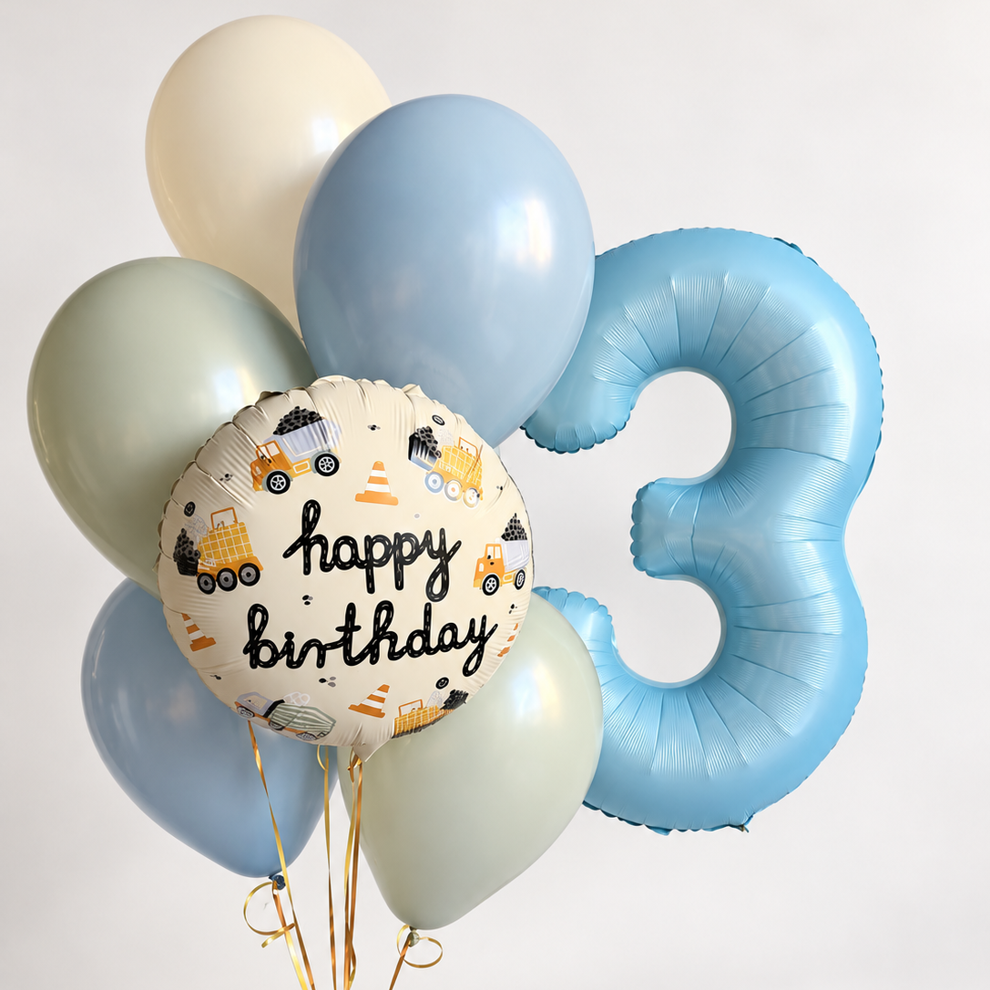 Blue number three balloon beside a construction truck birthday foil balloon and a bunch of blue, cream and sage green latex balloons.