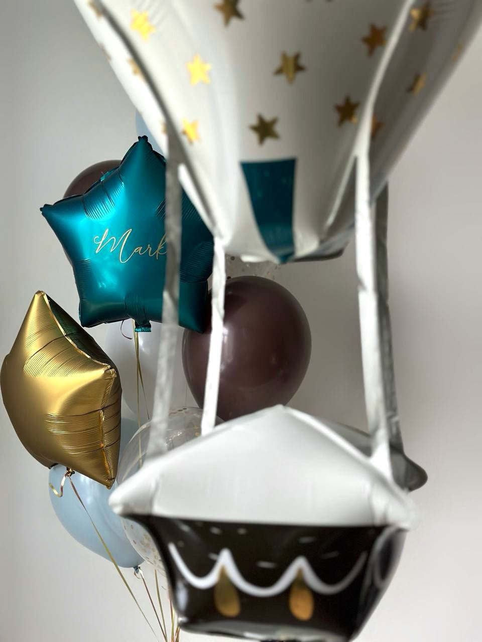 Travel-inspired baby balloon decor with air balloon foil balloon and custom sign in Manhattan