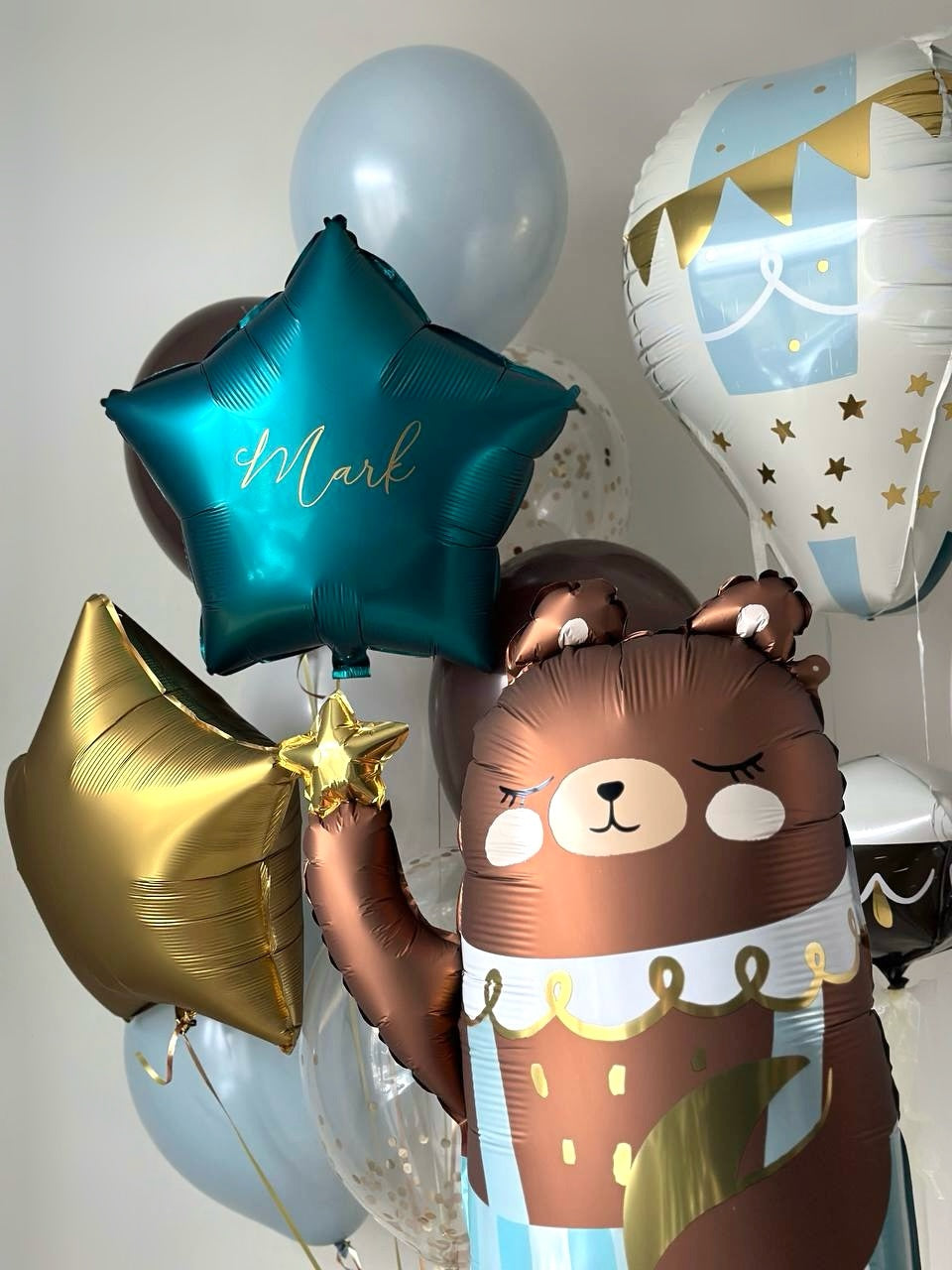 Close-up of twinkle bear balloon set with blue star balloons and teddy bear styling in Brooklyn