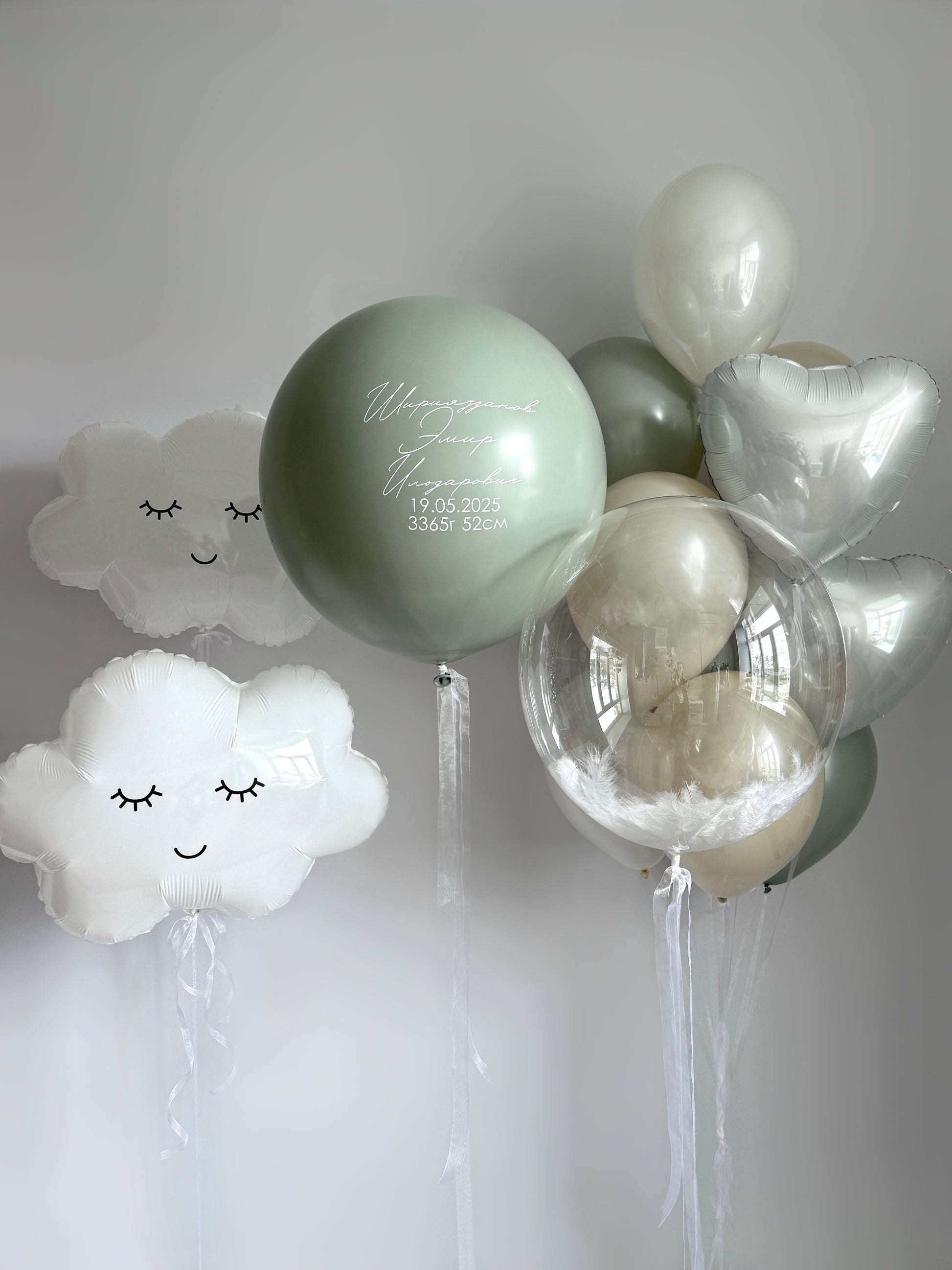 Under the trees balloon set with cloud balloons, feather bubble balloon, and custom sign for baby celebration decor in New York