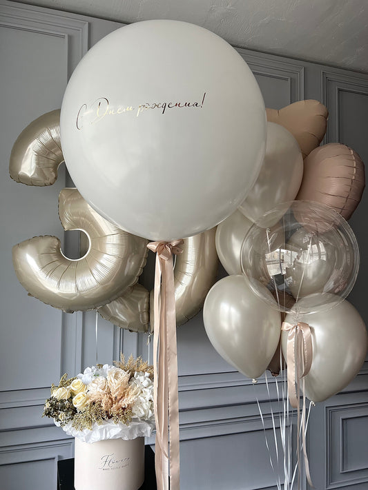 Warm celebration balloon set with custom sign balloon, number balloons, and neutral birthday decor in New York