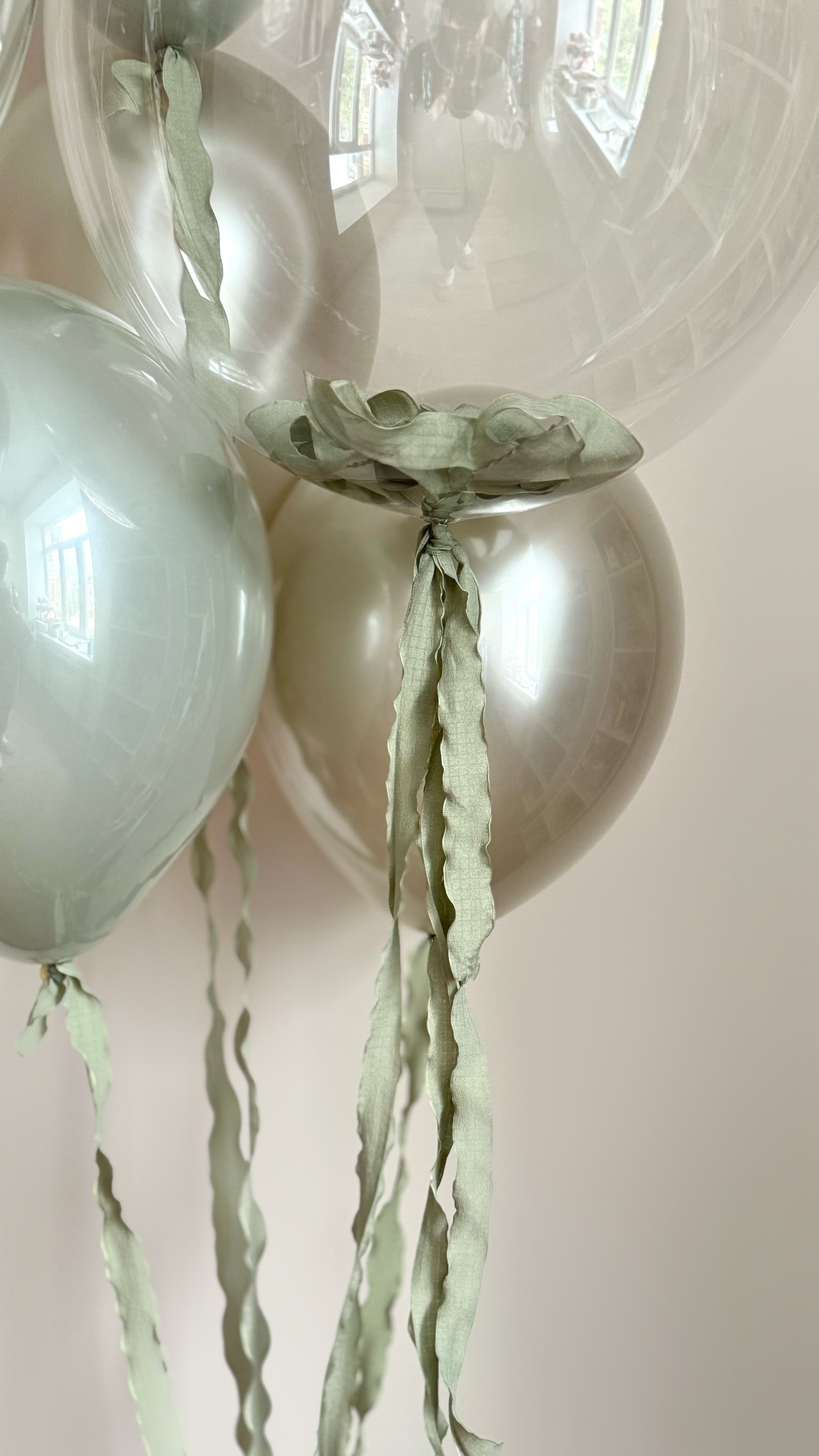 Close-up of white gold bubble balloons with ribbon decor for celebration styling in Brooklyn